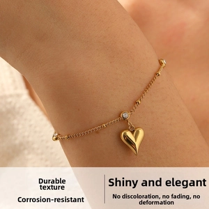 Macro close-up of a gold-plated heart pendant with sparkling cubic zirconia on a delicate chain