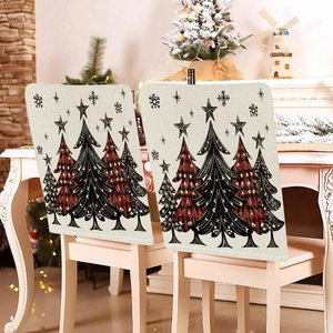 Close-up of linen Christmas chair covers with festive red plaid tree and snowflake motifs