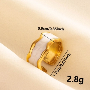 Detailed macro shot of 0.9cm wide irregular gold ring with white enamel finish