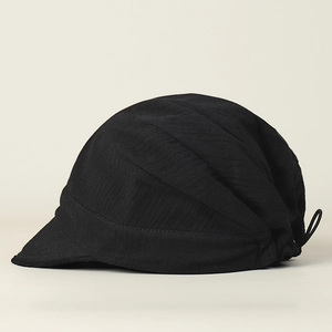 Detail of black breathable beret with pleated texture and adjustable elastic drawstring
