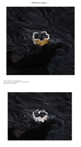 Detailed view of embossed 925 silver arabesque patterns on retro open rings