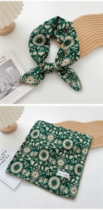 Detail of dark green cotton linen square scarf with beige floral patterns and lace edges
