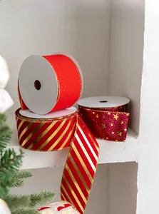 Detail of red and gold Christmas ribbons with star patterns on a festive backdrop