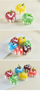 Macro detail of heart-shaped miniature cakes with colorful fruit toppings and cream