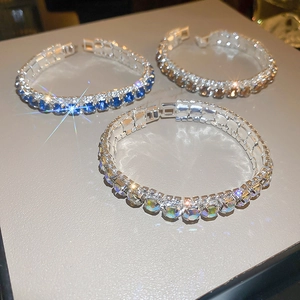 Elegant tennis bracelet set with geometric clasps in blue, white, and champagne stones