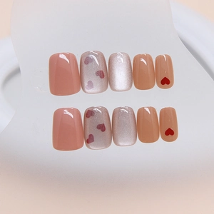 Cat eye press-on nails with heart designs and soft pink shimmer in short ballet shape