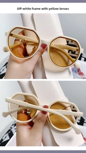 Close-up of cream retro polygonal sunglasses with yellow lenses and matching leather pouch