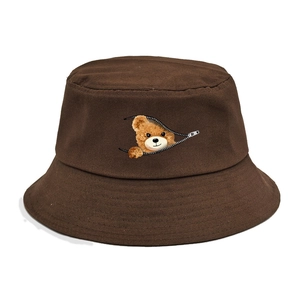 Detail of coffee brown cotton bucket hat with a cute bear peeking through a zipper design