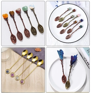 Macro shot of creative bronze dessert spoons with natural crystal tops and floral carvings