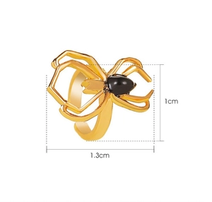 Macro view showing golden spider ring dimensions 1.3cm x 1cm with black gemstone
