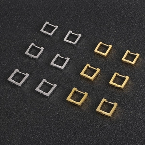 Minimalist geometric square hoop earrings in gold and silver finish on black background
