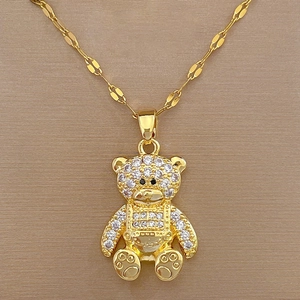 Detailed close-up of golden bear pendant with white zircon inlays on an O-chain