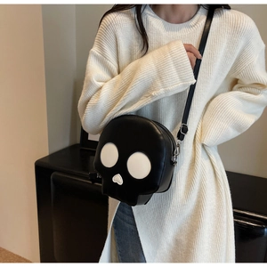 Close-up of skeleton crossbody bag featuring heart-shaped nose and silver metal buckle