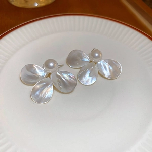 Detailed view of elegant mother of pearl flower earrings with a center pearl