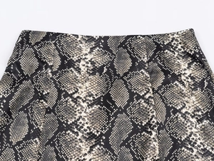 Detailed view of snake print satin midi skirt waistline with seamless stitching