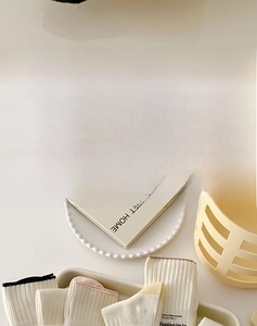 Detailed knit texture of soft cotton crew socks in warm pastel cream colors