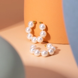 Minimalist 18k gold plated stainless steel C-hoop earrings with large pearls on geometric props