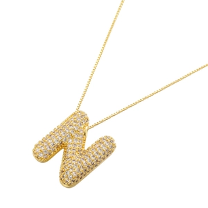 Detailed macro view of gold-plated letter N pendant featuring shimmering micro-pave zircons