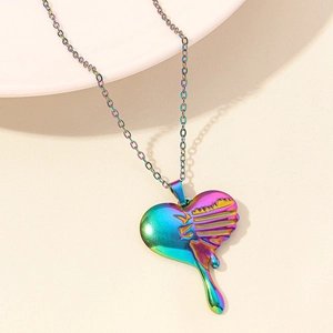 Macro detail of a melting heart pendant with iridescent colorful electroplated finish