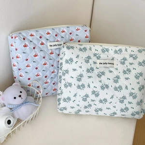 Quilted floral cosmetic pouches in light blue and beige with zipper and jolly house label