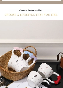 Detail of creative butterfly handle ceramic mugs with cute cartoon cat and floral patterns
