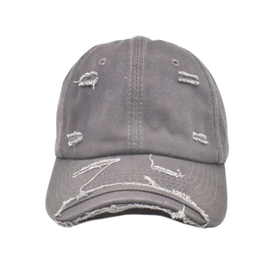 Close-up of a distressed dark grey cotton baseball cap with vintage worn-out details