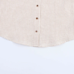 Detail of light brown vertical stripe shirt with cotton-linen texture and resin buttons