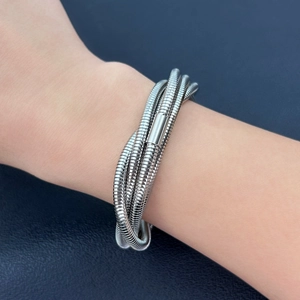 Close-up of five-layer silver stainless steel spring bracelet with metallic buckle