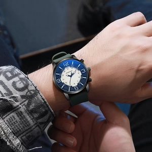 Close-up of stylish men's watch featuring a white dial, blue numerals and a green strap