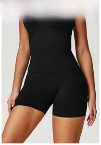 Front view of seamless high-waist black yoga shorts and sports top on fitness model