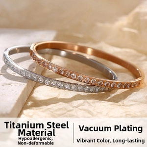 Close-up of titanium steel bangles in rose gold and silver with full zircon inlay