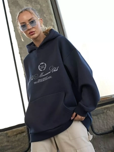 Navy blue oversized hoodie with The Movement Club lettering and a front kangaroo pocket