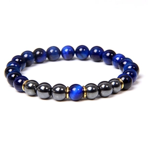 Detailed close-up of 8mm blue tiger eye beads and golden metal spacers on a beaded bracelet
