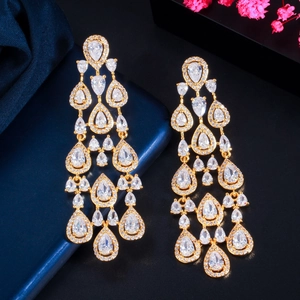 Elegant gold-tone tassel earrings with micro-set pear-cut cubic zirconia on blue background