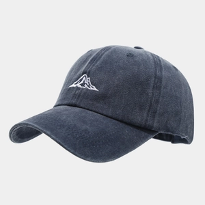 Detail view of washed navy baseball cap with mountain embroidery and curved brim