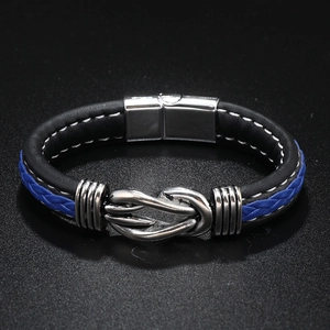 Detailed close-up of blue and black braided leather bracelet with silver magnetic metal clasp