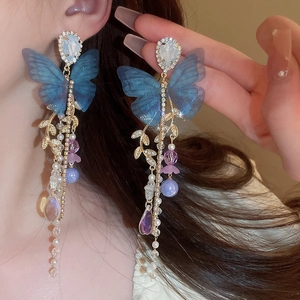 Elegant blue butterfly tassel earrings with crystal diamonds and pearls on model