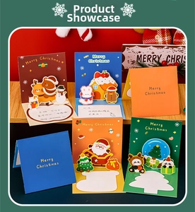 3D pop-up Christmas cards set featuring Santa, reindeer and trees on wooden desk