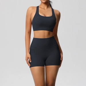 Detail of high-waist black sports shorts and racerback bra with moisture-wicking fabric