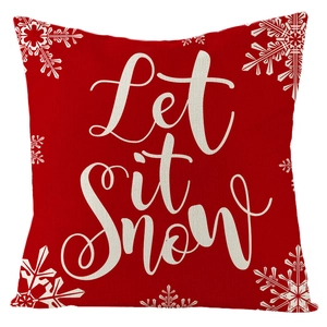Red Christmas linen pillow cover featuring white Let it Snow text and snowflake patterns