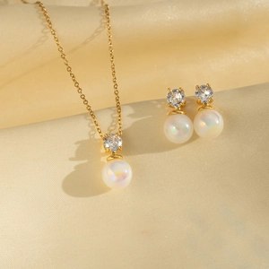 Detail view of pearl and zircon jewelry set on luxury silk background fabric