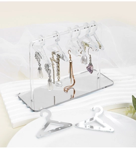 Clear acrylic jewelry organizer with mini hangers and mirror base for earring display