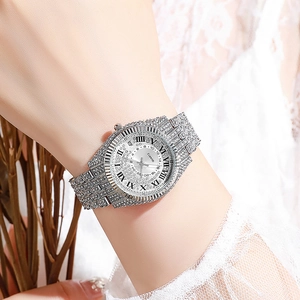 Macro shot of a luxury silver quartz watch for women with full diamond inlay on lace