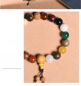Close-up of Eighteen Seeds bracelet with natural agarwood, tiger eye and agate beads