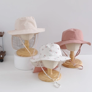 Foldable kids sun hats with neck flaps in beige, pink, and cherry prints for outdoor protection