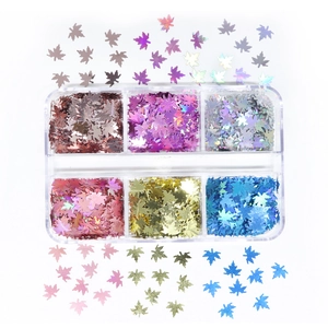 Macro view of six-grid box with laser maple leaf nail sequins in various holographic colors
