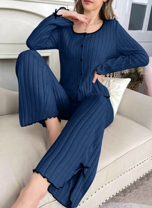 Detail of navy blue ribbed lounge set featuring black lettuce trim and bow accents