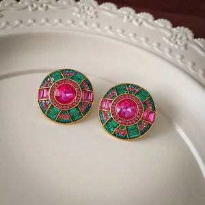 Detailed macro view of vintage round stud earring with colorful crystal inlay on lace plate
