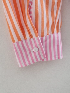 Detail of color block striped shirt cuff with single button and fine stitching