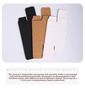 Flat lay of black, kraft, and white rectangular folding gift boxes for cosmetics